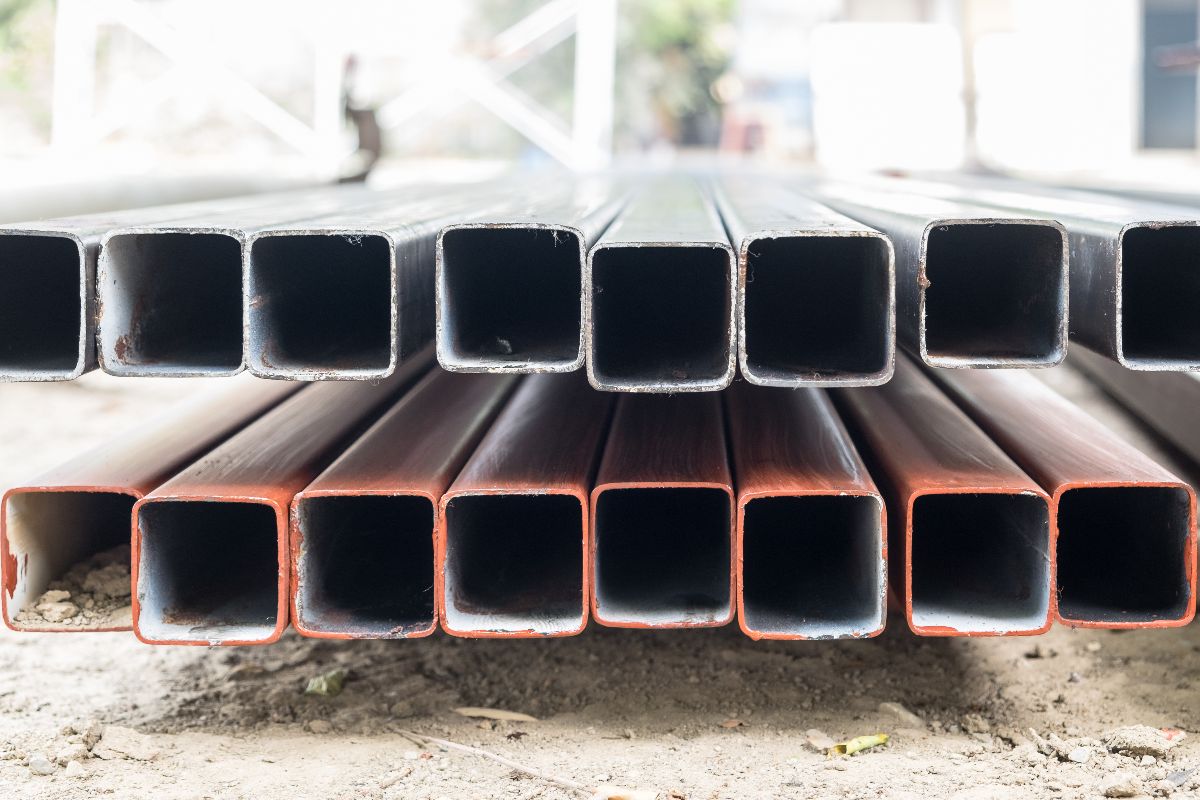 Close-up of square steel pipes arranged in rows for construction and fabrication use
