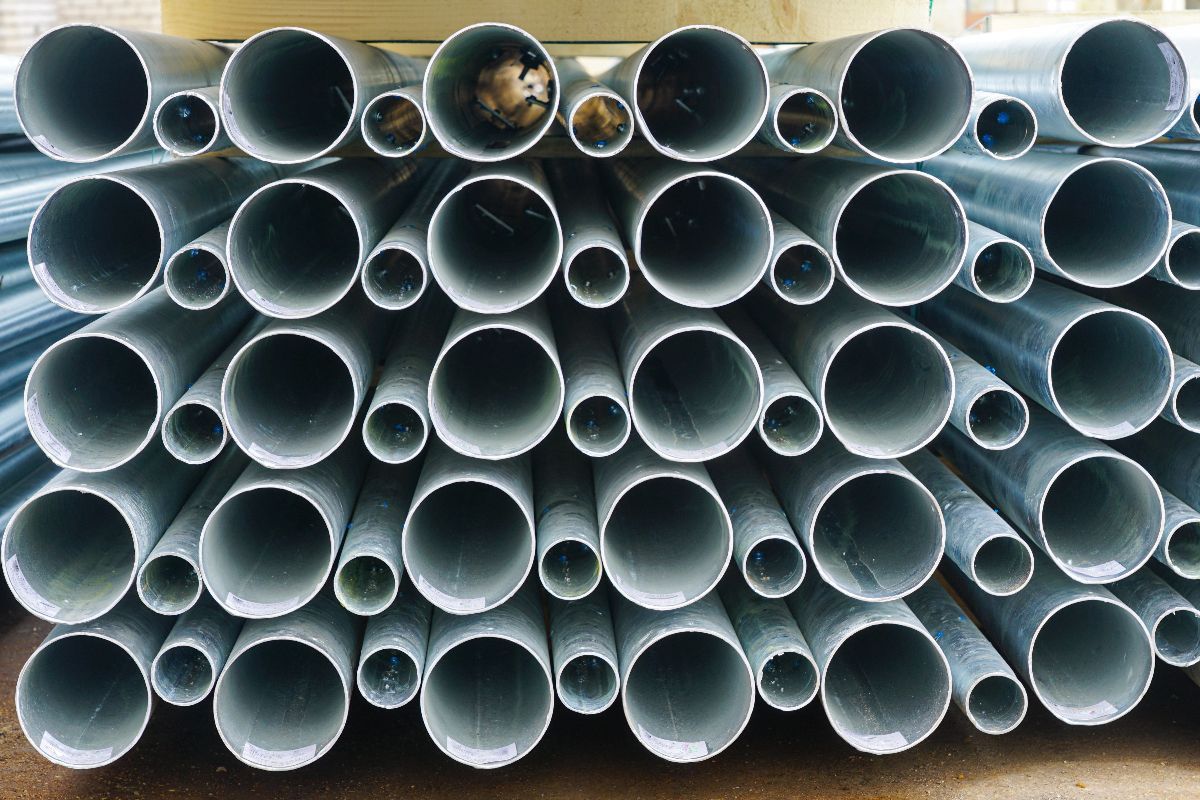 Close-up of galvanized pipe openings showing different pipe sizes and smooth metal surfaces