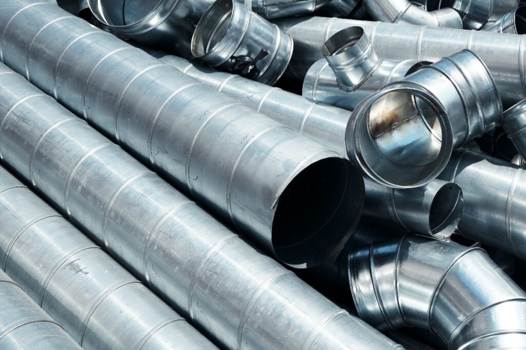 Galvanized spiral pipe fittings and duct sections prepared for industrial and construction use