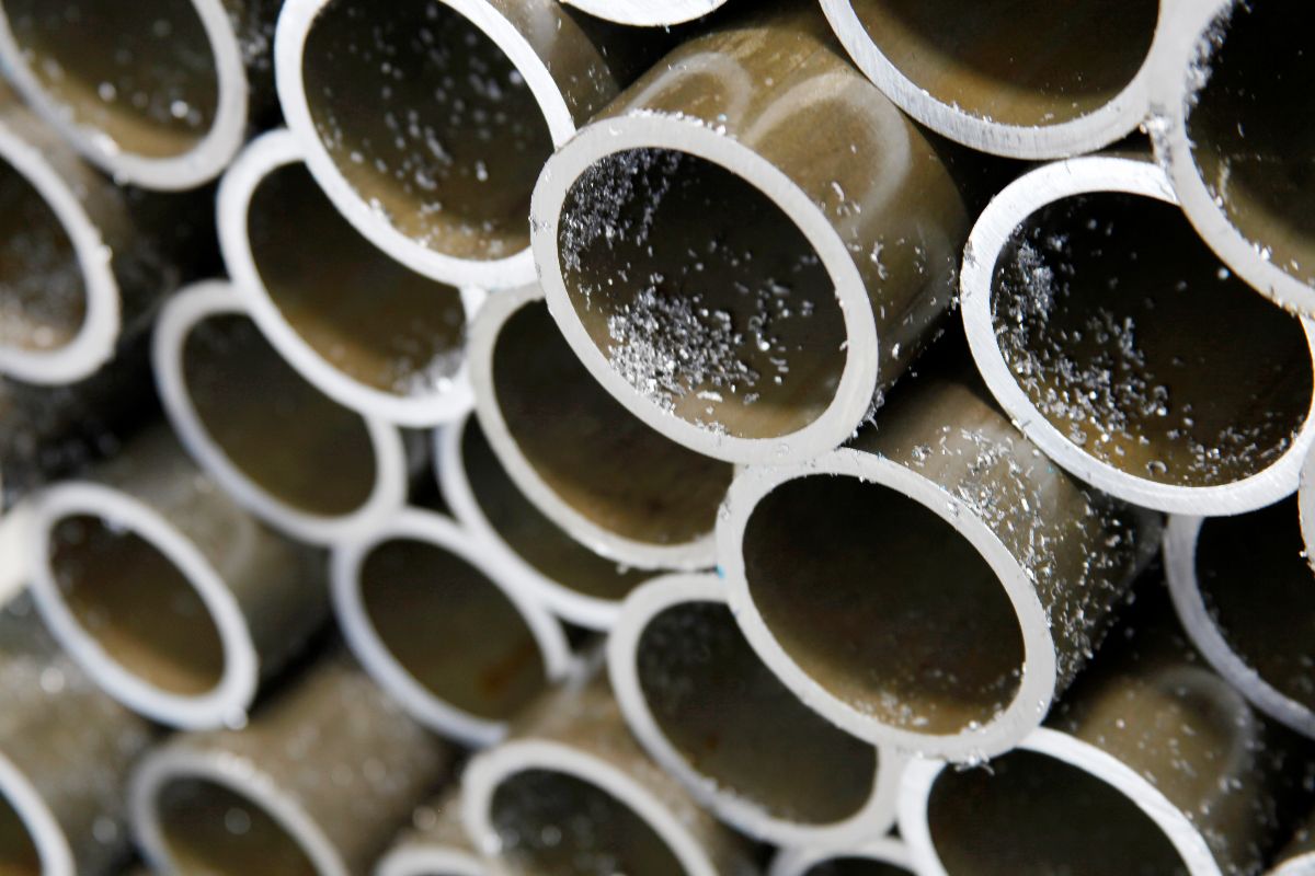 Close-up of galvanized iron pipe openings showing metal edges and protective coating